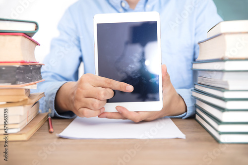 Male teacher learning to use tablet