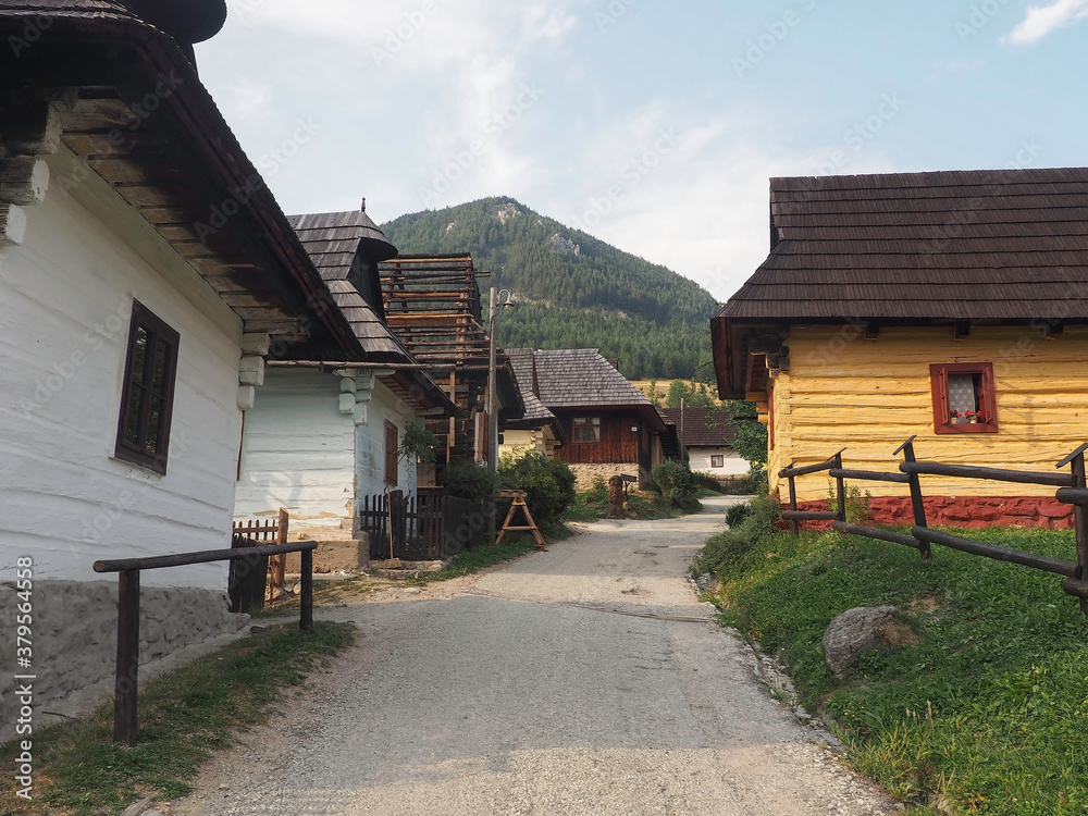 VLKOLINEC, SLOVAKIA, EUROPE, SUMMER 2015. Beautiful street in the center of Vlkolinec village, a Unesco heritage site. The houses are made of wood and painted in neutral colors.