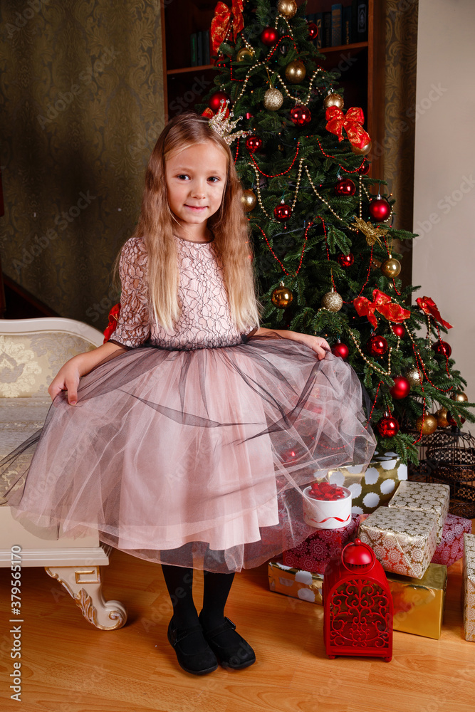 a cute little girl in a dress getting ready for New Year's.