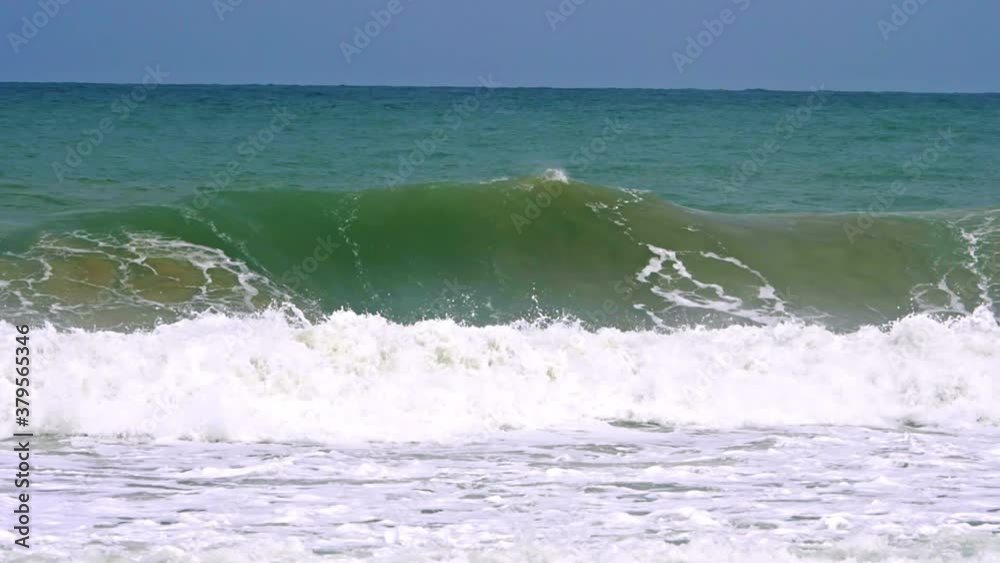 Close up of slow motion barreling wave with wind spray and raw natural Close up of slow motion barreling wave with wind spray and raw natural