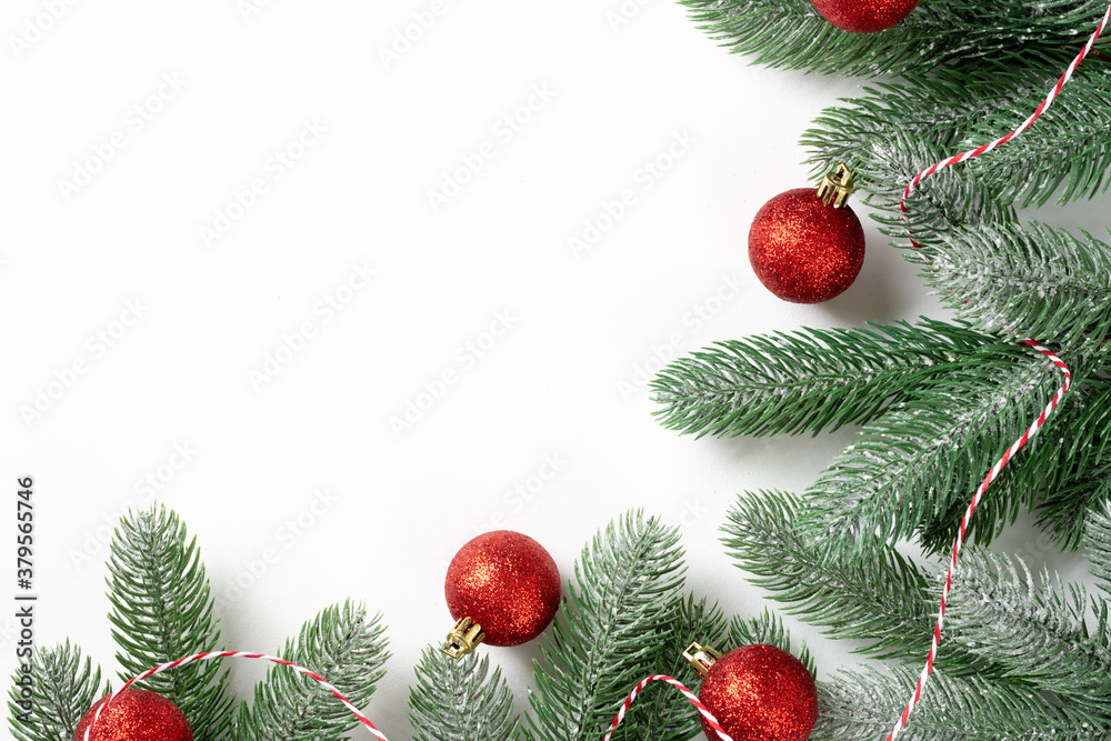 Christmas background. Red decorations on spruce branches on a white background. Christmas Flatly. Top view from copyspace Christmas background. Red decorations on spruce branches on a white background. Christmas Flatly. Top view from copyspace