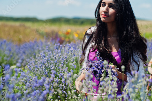 Beautiful indian girl wear saree india traditional dress in purple lavender field.