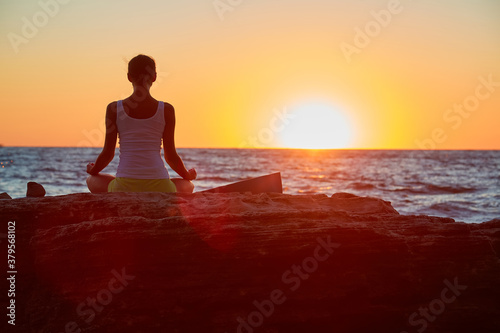 Lady meditating enjoy sunset. Virgin nature and fresh air. Contemplation, yoga meditation, stretch concept. Copy space