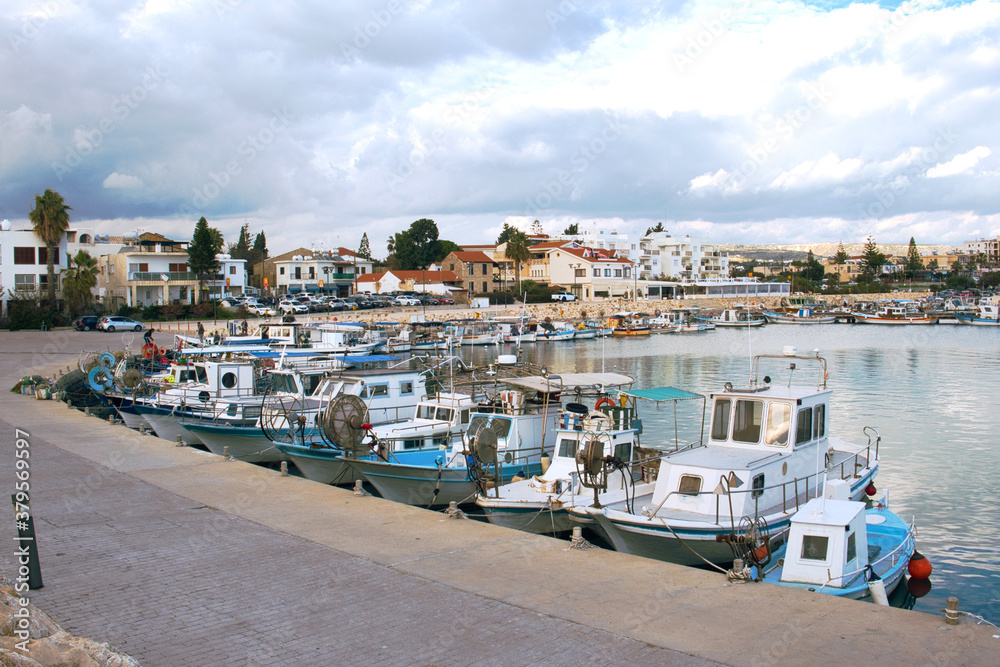 Old fishing boats in the Mediterranean sea harbor of fishing village Zygi on Cyprus island