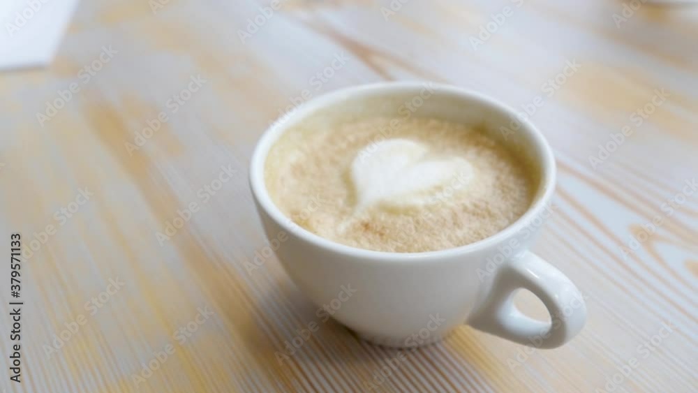 Heart shaped design on a cappuccino coffee Heart shaped design on a cappuccino coffee
