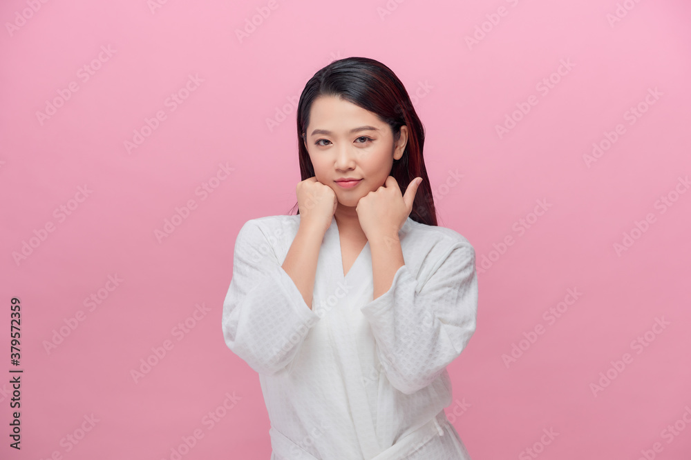 Portrait of young Asian woman smiling friendly with hands on chin Portrait of young Asian woman smiling friendly with hands on chin