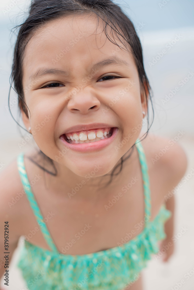 Little girl playing on the beach on summer holidays. Children in nature with beautiful sea, sand and blue sky. Happy kids on vacations at seaside running in the water. . Little girl playing on the beach on summer holidays. Children in nature with beautiful sea, sand and blue sky. Happy kids on vacations at seaside running in the water. .