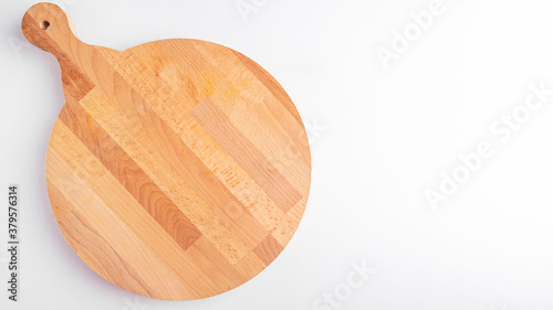 Top view of empty round pizza boardon a white. Wooden pizza board with copy space photo