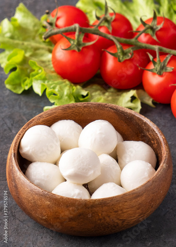 Mozzarella cheese in a wooden bowl. Closeup