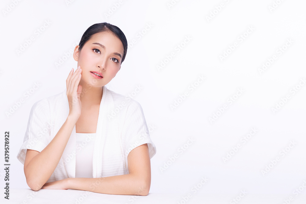 Charming young woman touching her face with clean fresh skin. Teenager with perfect skin over isolated white background. Beauty cosmetics and healthy concept. Charming young woman touching her face with clean fresh skin. Teenager with perfect skin over isolated white background. Beauty cosmetics and healthy concept.