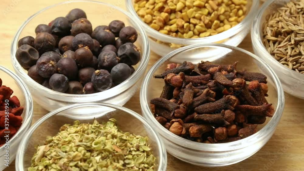 Glass bowls with a variation of dried spices close up Glass bowls with a variation of dried spices close up