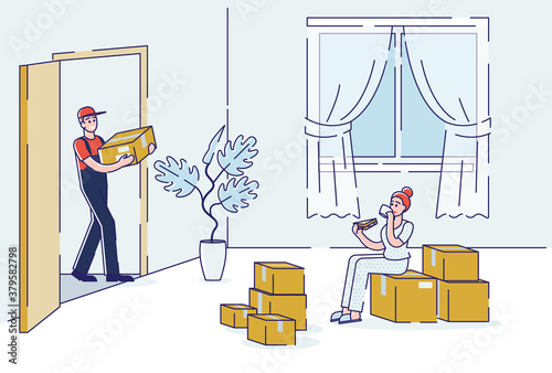 Courier bringing cardboard boxes in living room for female client of delivery service