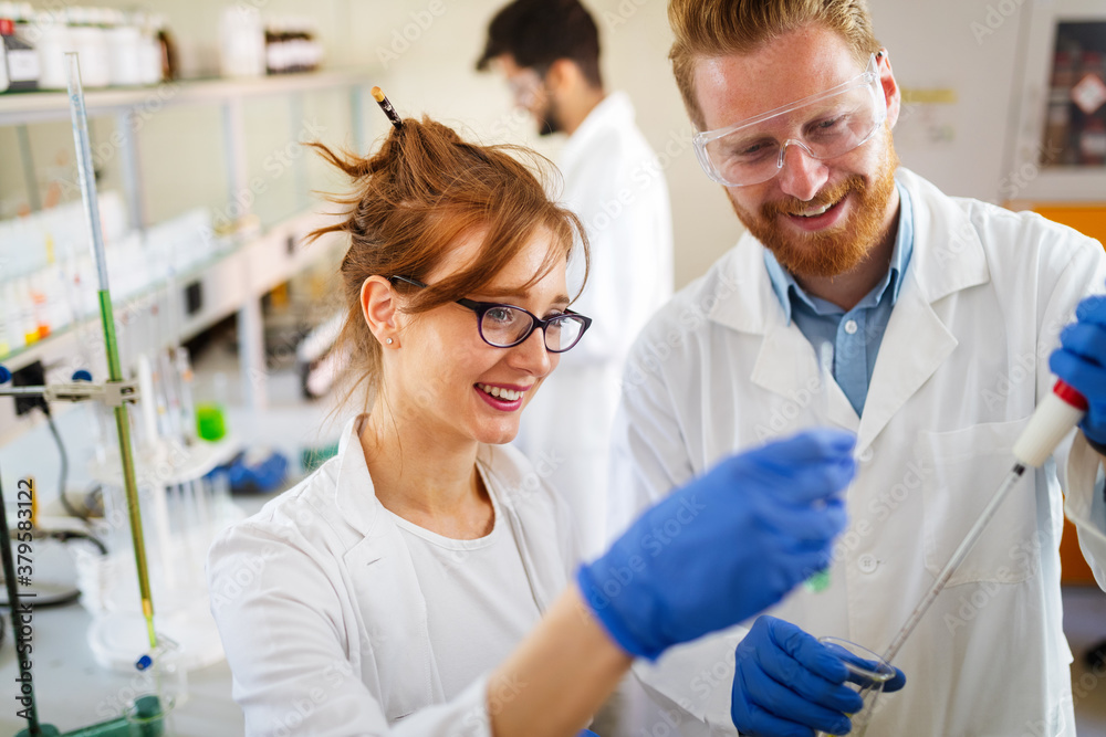 Group of medical scientists working at laboratory. Science, chemistry, medicine and people concept Group of medical scientists working at laboratory. Science, chemistry, medicine and people concept