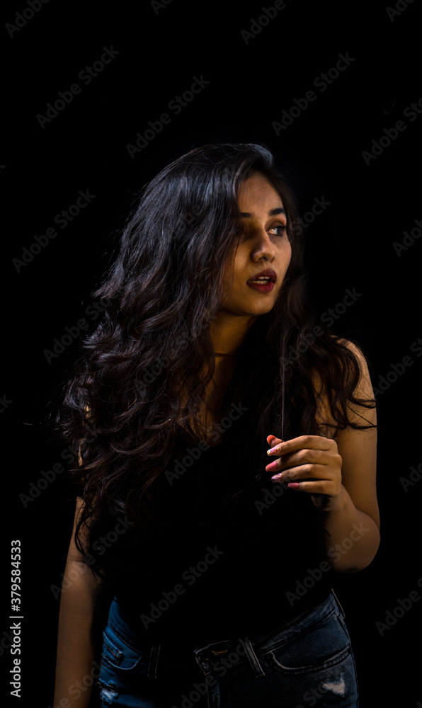 Woman in black. low key portrait of beautiful Indian girl Stock Photo