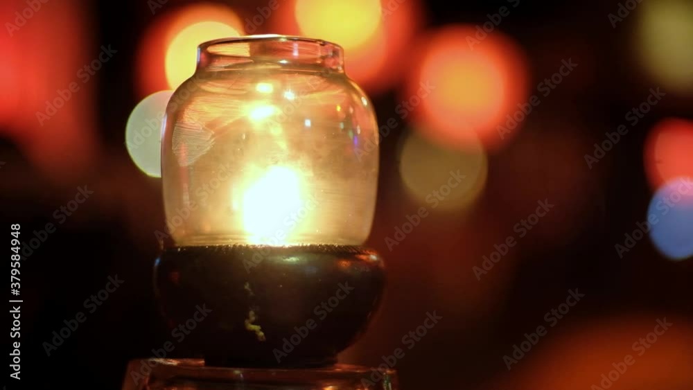 Sunset on an island beach with oil lanterns lamp illuminating the romantic scene. Blurred bokeh on background. Chillout cafe bar on the beach Sunset on an island beach with oil lanterns lamp illuminating the romantic scene. Blurred bokeh on background. Chillout cafe bar on the beach