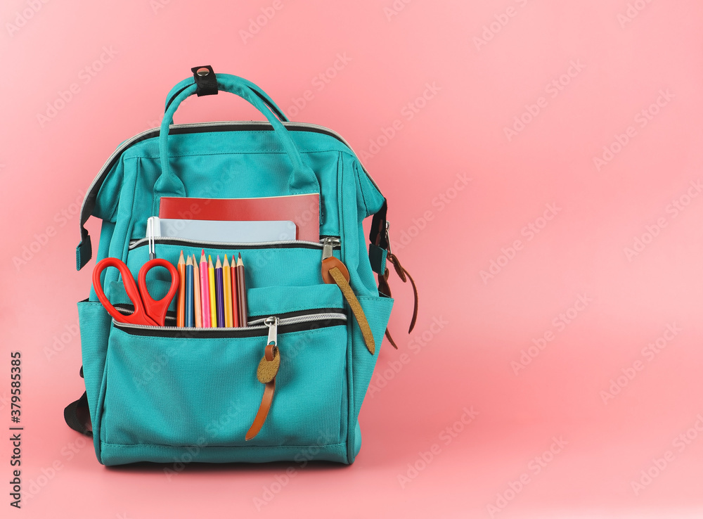 backpack with school supplies on pink background with copy space. Back to school and education concept. backpack with school supplies on pink background with copy space. Back to school and education concept.