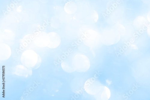 Bokeh light on blue background, sky with circle glitter light blue. Snow abstract soft glowing with vivid bright light and bokeh blur effect. 