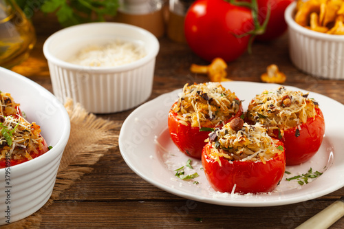 Baked stuffed tomatoes. Stuffed with chanterelles. Top view of the dish.