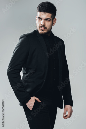 handsome serious man in black suit