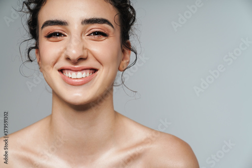 Image of joyful half-naked woman laughing and looking at camera