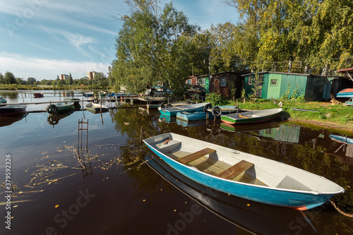 Floating fishing  village with boats at rest on a sunny autumn day. © Daria