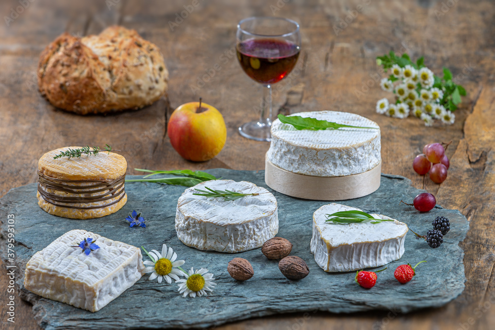 Selection of different types of cheese. Tasty and fresh cheese, with glass of wine, wooden background
