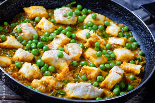 fish curry with green peas, top view