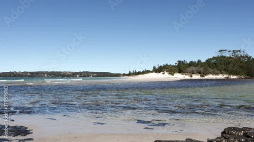 Rocky beach shore at Moona Moona Creek entering Jervis Bay waters in Australia, Locked Shot photo