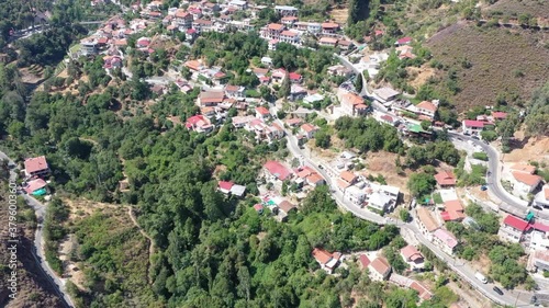 Village in the mountains, in a gorge, Greek, Italian, Spanish, southern, European. Houses with tiled roofs. The village stands on a steep mountainside photo