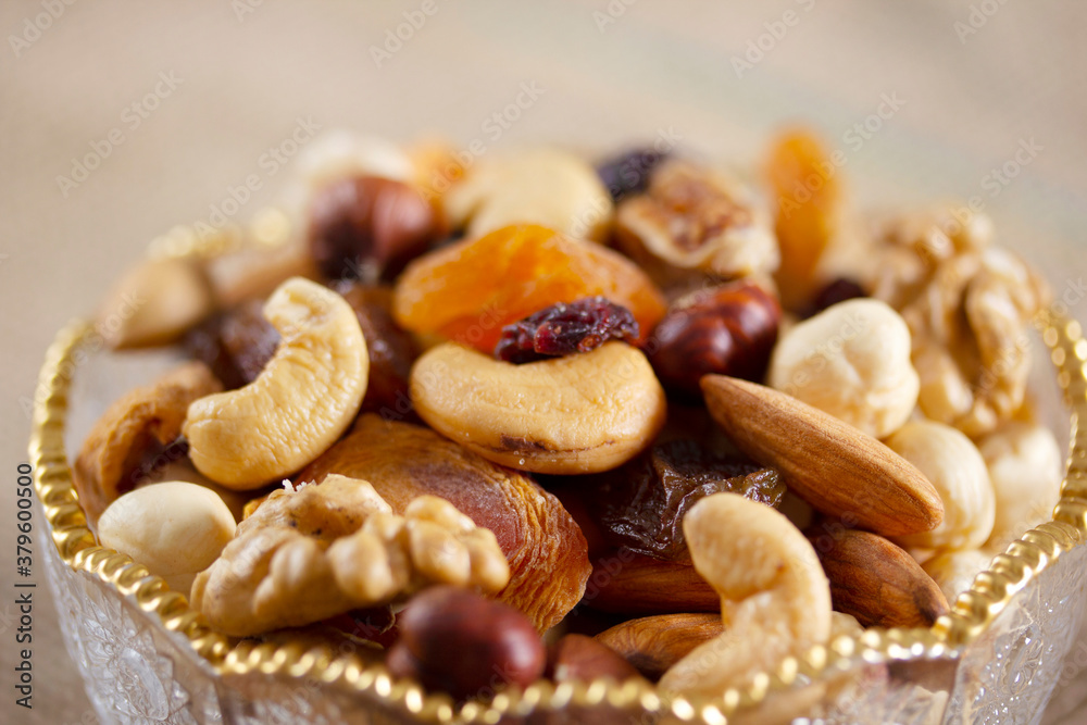 Mixed nuts in a glass plate. Healthy and natural nutrition .Cashew, Almond,, Hazelnut,, Fig,, Walnut,, Apricot,, Raisin,, Blueberry. Mixed nuts in a glass plate. Healthy and natural nutrition .Cashew, Almond,, Hazelnut,, Fig,, Walnut,, Apricot,, Raisin,, Blueberry.