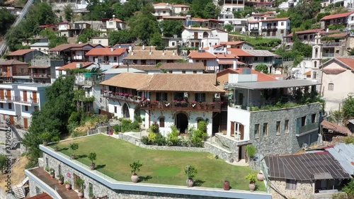 Village in the mountains, in a gorge, Greek, Italian, Spanish, southern, European. Houses with tiled roofs. The village stands on a steep mountainside photo