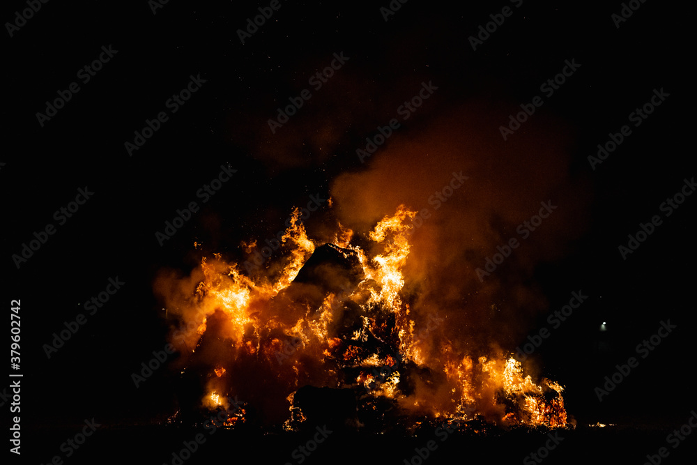 Hot red burning large fire with the black starry night sky. Hot red burning large fire with the black starry night sky.