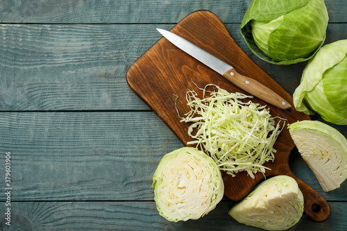 Valokuva Chopped cabbage on blue wooden table, flat lay. Space for text