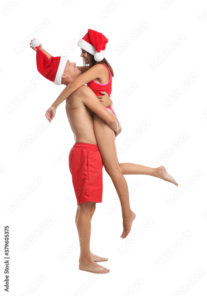 Happy couple with Santa hats together on white background. Christmas vacation Happy couple with Santa hats together on white background. Christmas vacation