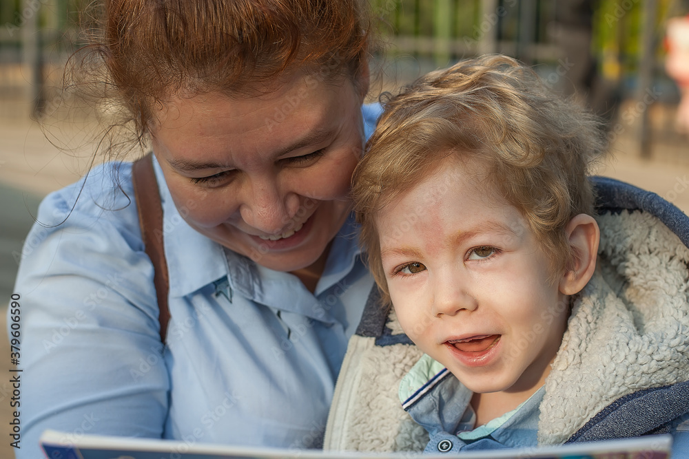 a disabled child with his mother laughs, hugs, smiles. a scene full of motherly love. His mother kisses him a disabled child with his mother laughs, hugs, smiles. a scene full of motherly love. His mother kisses him