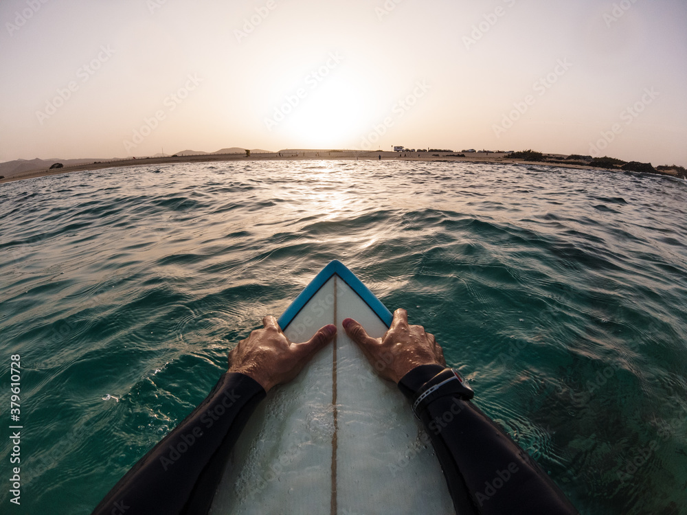 Surfer pov watching sunset in the water sitting on his surf board - Freedom, holidays, vacation concept - obrazy, fototapety, plakaty 