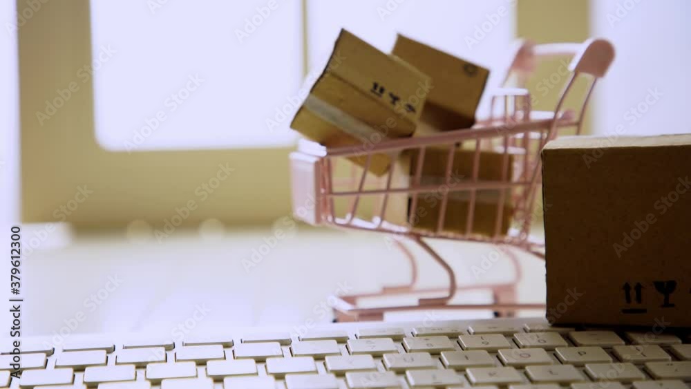 Shopping cart with boxes on keyboard . The concept of delivering and online shopping.