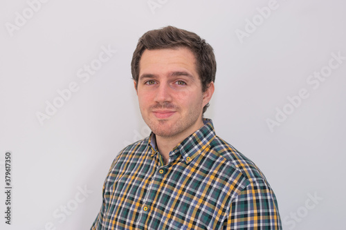 Photo of a young and attractive man wearing a shirt smiling at the camera looking very professional. Casual business man, corporative. © Irene Castro Moreno