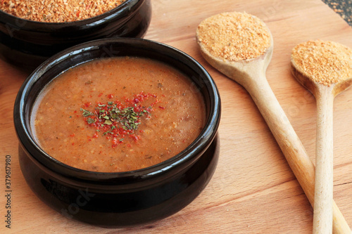 Traditional Turkish Homemade Dry Soup,Tarhana grains and cooked in casserole bowl on wooden tray with wooden spoons