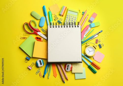 Blank notebook and school stationery on yellow background, flat lay with space for text. Back to school