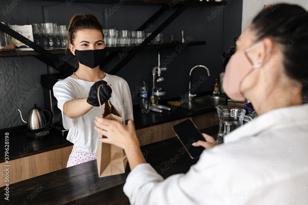 Woman barista wearing medical mask