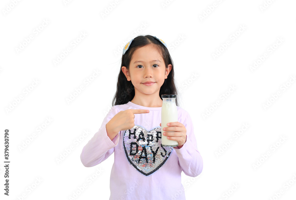 Portrait asian little kid girl hold and pointing at milk glass bottle in hand isolated on white background. Portrait asian little kid girl hold and pointing at milk glass bottle in hand isolated on white background.