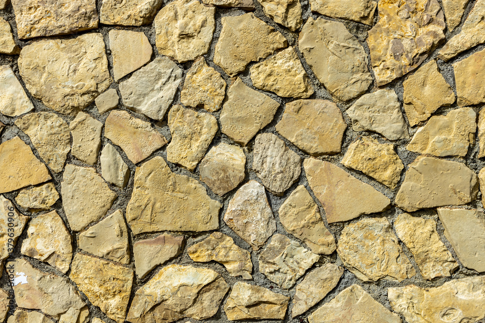 Old stone wall background texture close up. Stone background. Old stone wall background texture close up. Stone background.