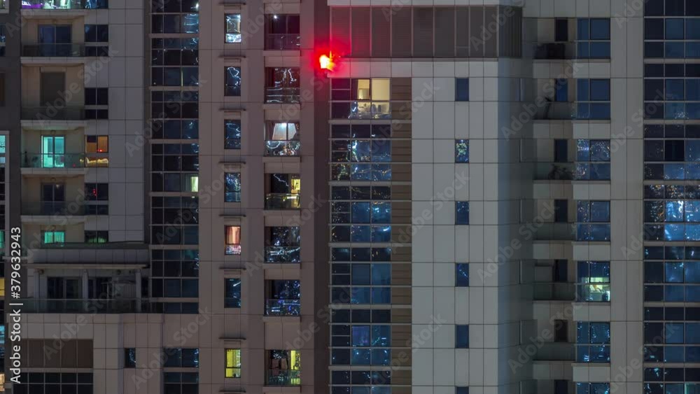 Lights from windows of offices and apartments aerial timelapse. Skyscrapers with working people in the evening in Business Bay, Dubai, United Arab Emirates. Complex of towers at night Lights from windows of offices and apartments aerial timelapse. Skyscrapers with working people in the evening in Business Bay, Dubai, United Arab Emirates. Complex of towers at night
