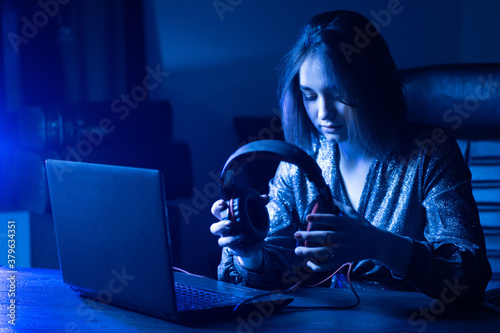 Girl holds headphones in he...