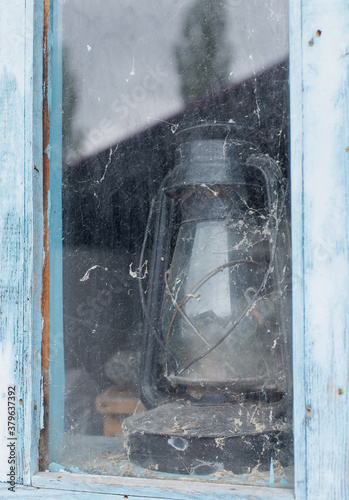 An old gas lamp stands outside the window