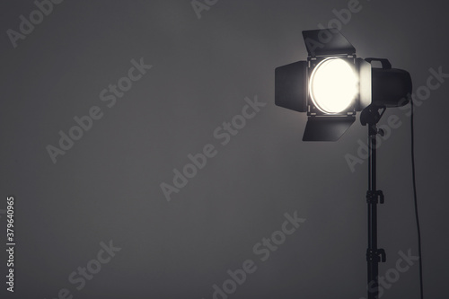 Studio lighting with tripod on black background