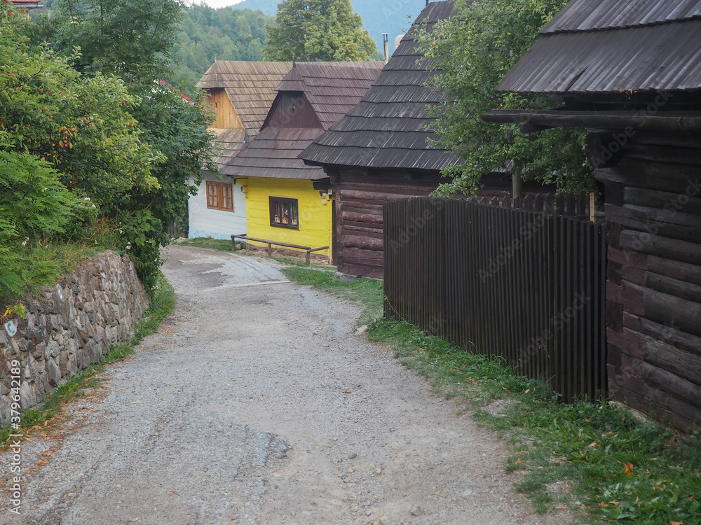 VLKOLINEC, SLOVAKIA, EUROPE, SUMMER 2015. Beautiful street in the center of Vlkolinec village, a Unesco heritage site. The houses are made of wood and painted in neutral colors.