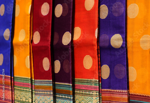 traditional Indian woman saris or sarees hung in display of a retail shop