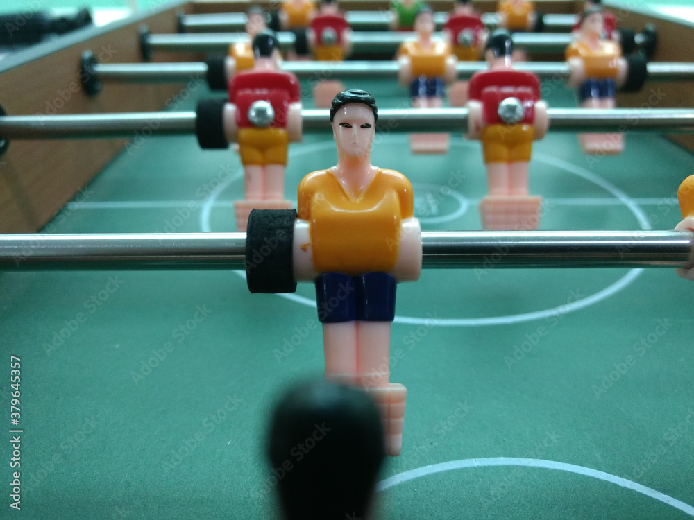 foosball table football game with red and yellow players foosball table football game with red and yellow players